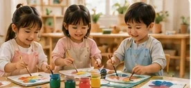 Children painting together at the art table